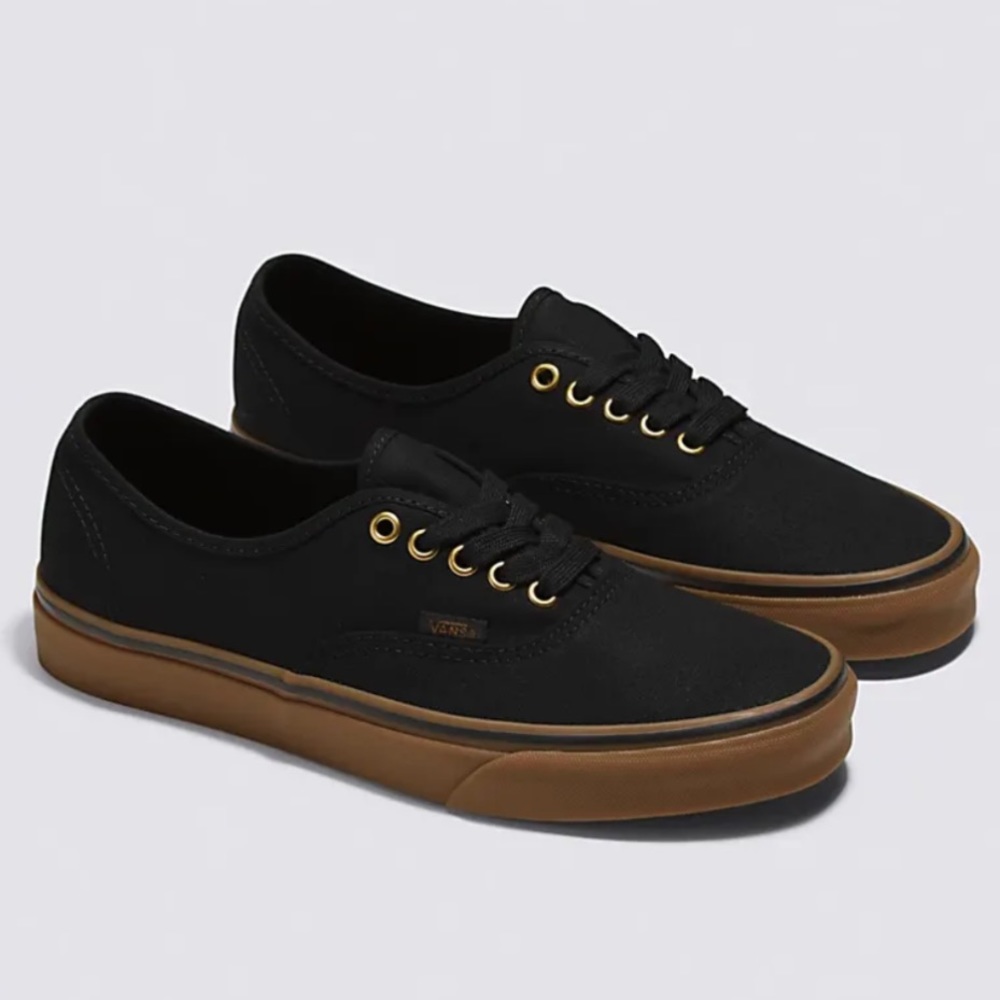 Black Vans with brown soles and gold lace holes